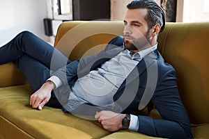 Stylish young man in a suit and bow tie. Business style. Fashionable image.