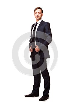 Stylish young man in suit and tie. Business style. Handsome man standing and looking at the camera