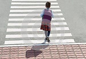 Stylish young teen girl walking with backpack. Active child. Kid runs across the crosswalk. Way forward. Direction to success.