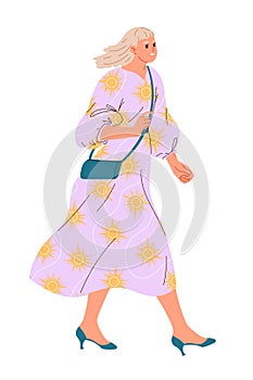 Stylish young walking woman in a loose light dress