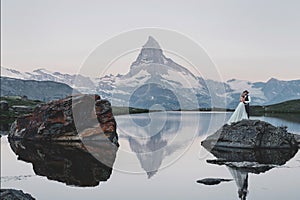 Stylish young wedding couple posing in beautiful Matterhorn moun