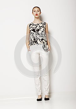 Stylish Young Woman Mod in Light Clothes over White Background. Fashion Style