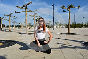 Stylish young woman modeling wearing sunglasses. Fashion photo shoot.