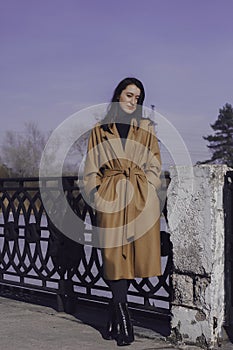 Stylish young woman out for a walk. she dressed and looks very fashionable.