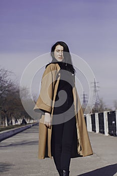 Stylish young woman out for a walk. she dressed and looks very fashionable.