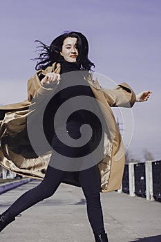 Stylish young woman out for a walk. she dressed and looks very fashionable.