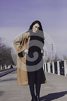 Stylish young woman out for a walk. she dressed and looks very fashionable.