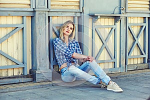 Stylish young woman in town . Girl dressed in jeans and a shirt