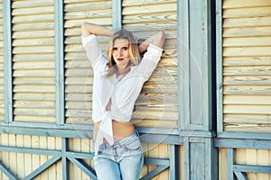 Stylish young woman in town . Girl dressed in jeans and a shirt