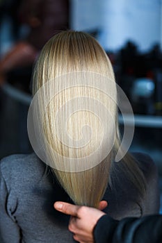 Stylist demonstrate female blonde hair