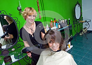 Stylist drying woman hair