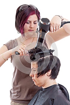 Stylist drying woman hair