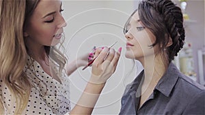 Stylist makeup artist doing makeup and hair in a beauty salon.