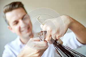 Stylist with scissors cutting hair tips at salon