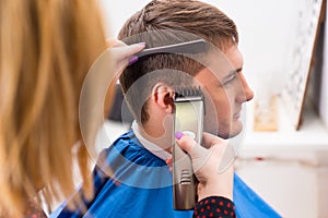 Stylist Using Razor to Cut Hair of Male Client