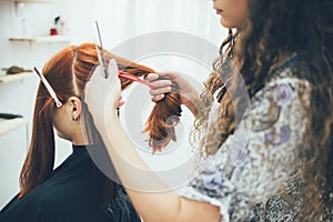 Stylist working in the beauty salon, haircut and hair styling