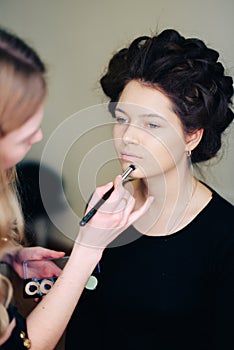 Stylist working in a beauty salon and a nice lady