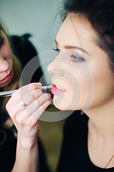 Stylist working in a beauty salon and a nice lady