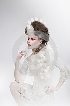 Stylization. Woman with Eggshells and Art Fancy Makeup. Fantasy photo
