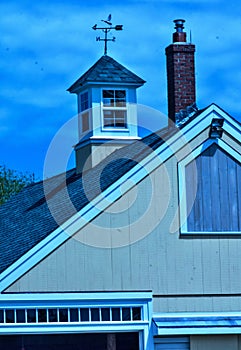 Stylized blues and yellow barn image with cupola and weathervane