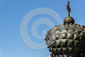 Stylized imperial crown against a blue sky.