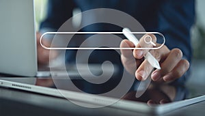 Stylus on tablet accessing a glowing digital search interface.