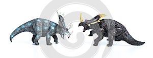 Styracosaurus and triceratops toys on white background