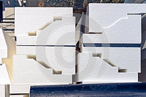 Styrofoam blocks for facade decoration and hiding construction joints are stored awaiting installation