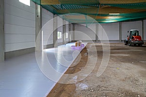 styrofoam panels are laid on the floor of a newly built factory building for insulation purposes