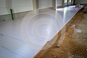 styrofoam panels are laid on the floor of a newly built factory building for insulation purposes