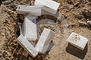 Styrofoam waste after facade insulation. polystyrene scraps on the ground close-up, top view. Builder at a construction site