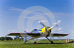 SU-26 russian sport airplane on the airfield with running motor