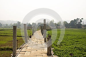 Su Tong Pae bamboo wooden bridge of Wat Phu Sa Ma temple for thai people and foreign traveler travel visit while PM 2.5 Dust