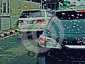 Suan Luang, THAILAND - 10 november 2018 : Traffic in rainy day on the road and rain drops on car window with tailing break light.