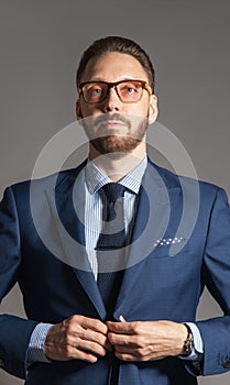 Suave handsome stylish bearded man in blue suit