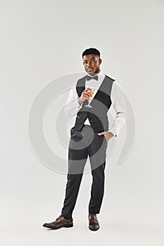 Suave man in tuxedo gracefully holds photo