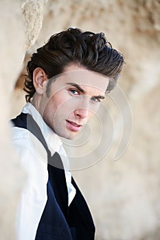Suave and smouldering. Closeup of a handsome young male wearing a vest and looking at the camera.