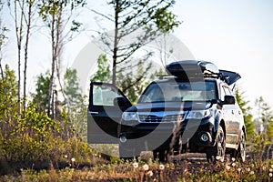 Subaru Forester with roof box at dirt road