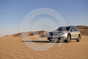 Subaru Outback standing in the middle of the Namib desert.
