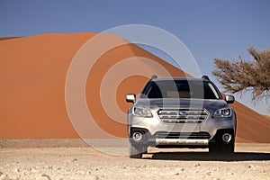 Subaru Outback stands in the middle of the Desert, next to a sand dune of Sossusvlei. 19.08.2021