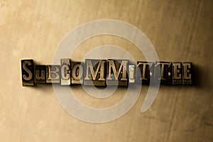 SUBCOMMITTEE - close-up of grungy vintage typeset word on metal backdrop