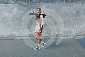 Subculture. Skater Girl With Skateboard At Skatepark Full-Length Portrait. photo