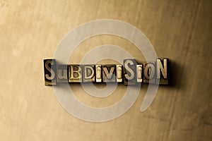 SUBDIVISION - close-up of grungy vintage typeset word on metal backdrop