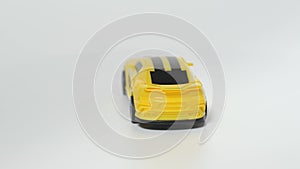 Subject shooting of a toy car. A model of a yellow sports car is on a spinning table.
