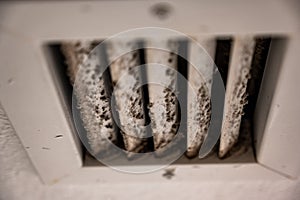 Subjective focus on lint and dirt particles on a ceiling air vent photo