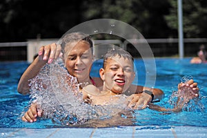 Sublings playing in a water park