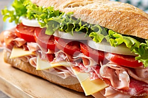 Submarine sandwich with ham, cheese, lettuce, tomatoes,onion, mortadella and sausage