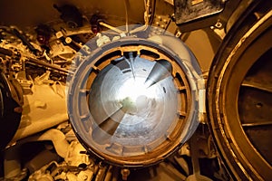 A submarine torpedo tube showing both hatches opened