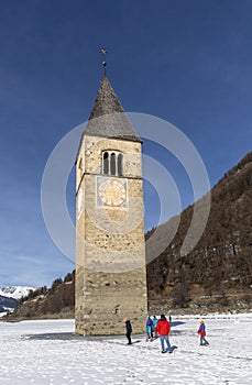 The submerged bell tower of Resia with snow