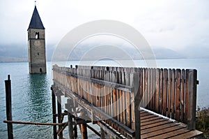Submerged tower of reschensee church deep in Resias Lake of Bolzano or bozen at Italy